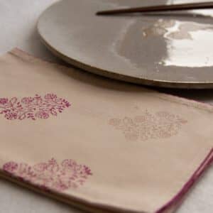 Napkin showing prints in the corner, and a dinner plate