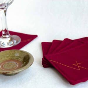 Six burgundy coasters with a wine glass and small dish