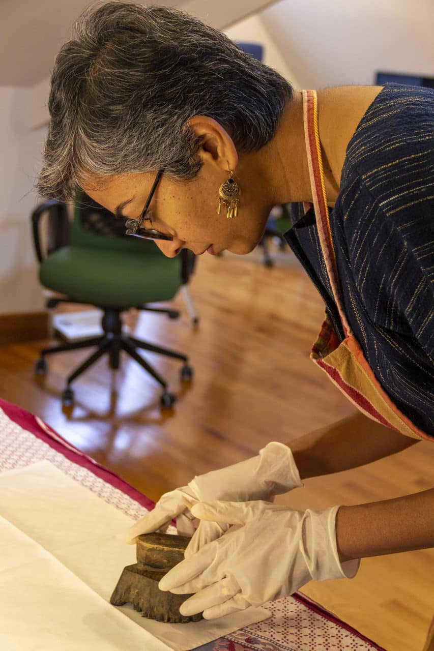 Person woodblock printing a fabric