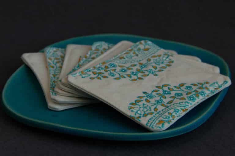 Four coasters on a plate.