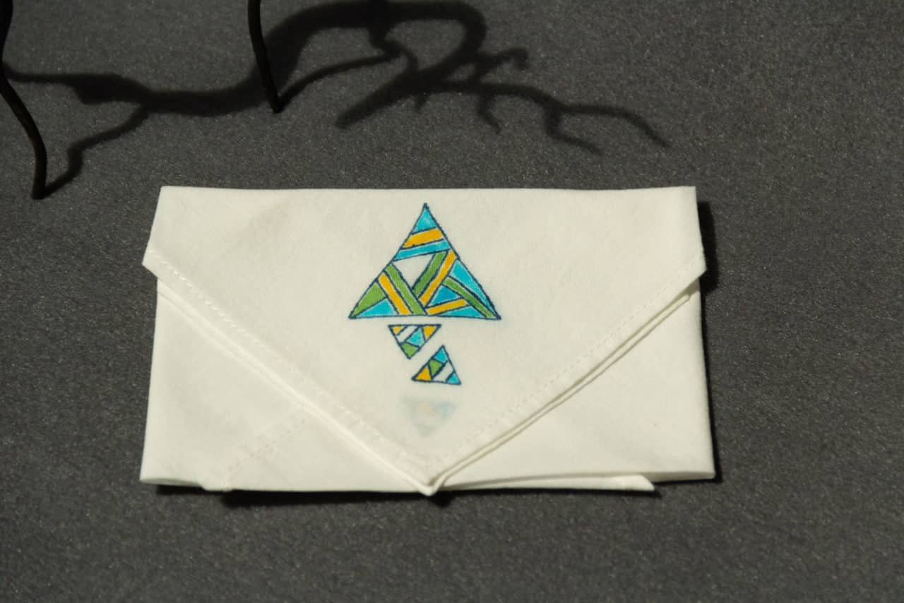 Folded handkerchief with colored triangle prints