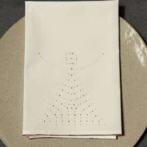 One napkin with dotted design on a plate