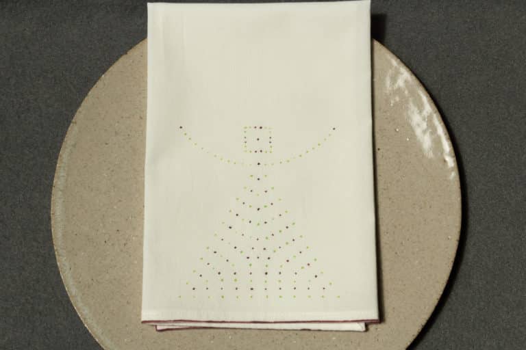 One napkin with dotted design on a plate