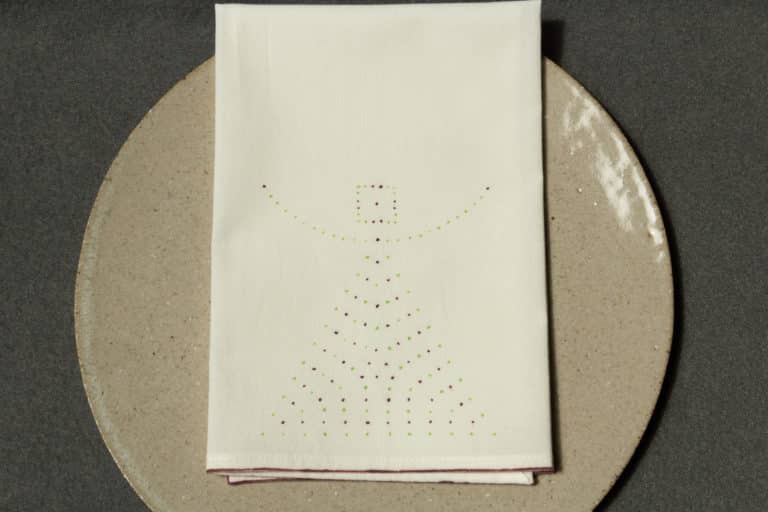 One napkin with dotted design on a plate