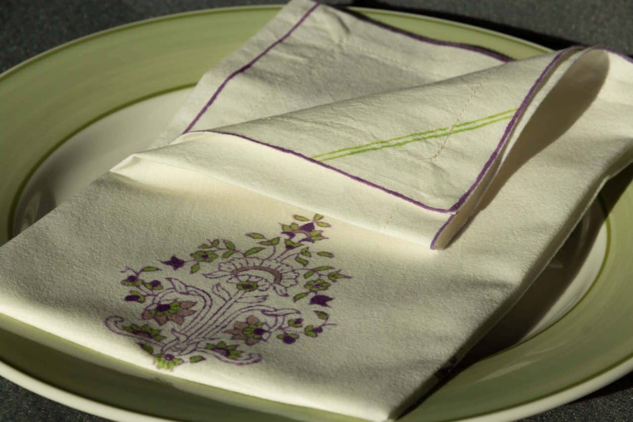 A single folded napkin on a dinner plate
