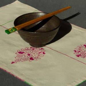 Single placemat with a ceramic bowl and chopsticks on top