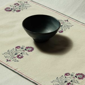 A single placemat with a bowl in the middle