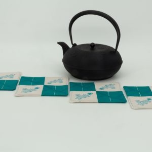 Four coasters and a cast iron kettle