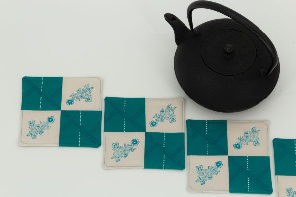 Three coasters and a cast iron kettle