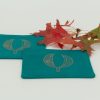 Two coasters with a sprig of oak leaves