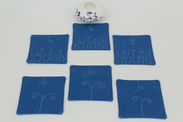 Six coasters with a ceramic cup