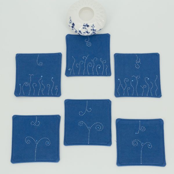 Six coasters with a ceramic cup