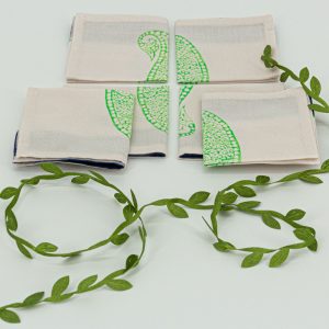 Six folded cocktail napkins with a decorative ribbon