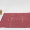 Unfolded handkerchief and a small stone figurine