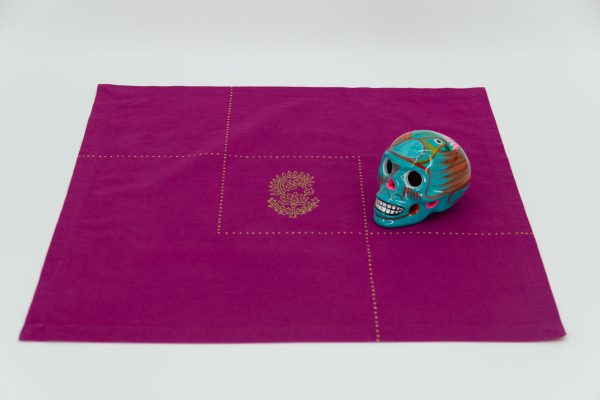 A single napkin with a Mexican skull sculpture