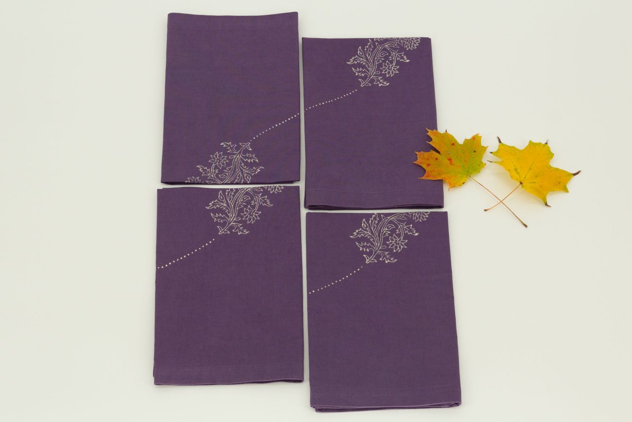 Four folded napkins with two maple leaves
