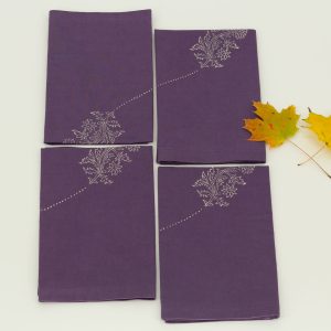 Four folded napkins with two maple leaves