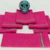 Six folded napkins with a ceramic Mexican decorative skul
