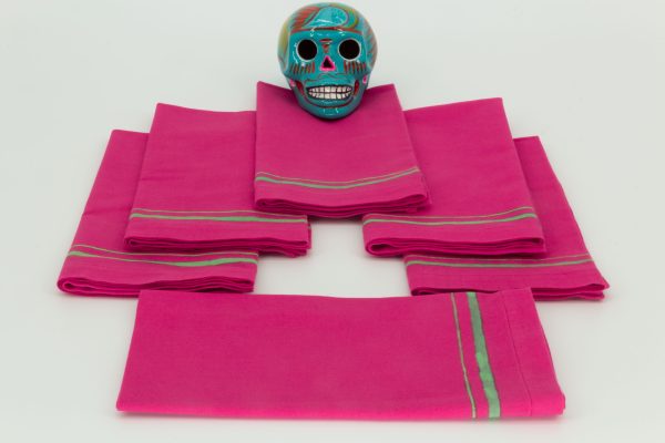 Six folded napkins with a ceramic Mexican decorative skul