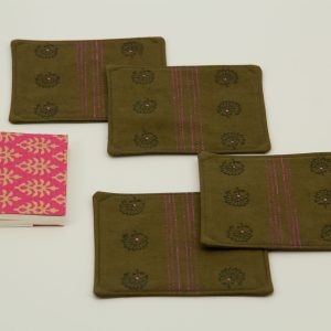 Four coasters next to a small notebook
